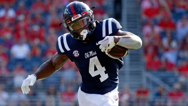 Ole Miss Rebels running back Quinshon Judkins on a rushing attempt during a college football game in the SEC.